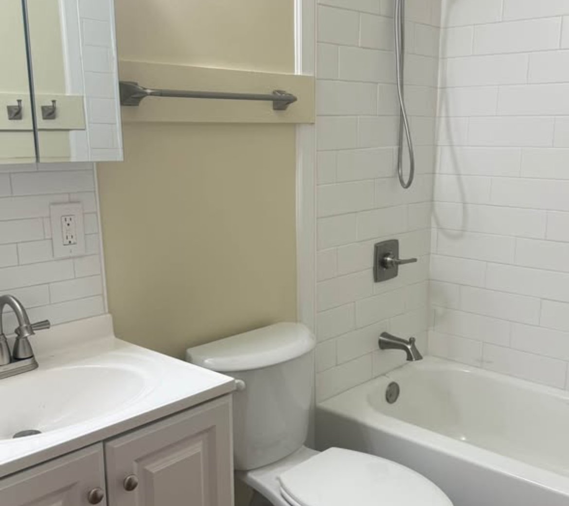 Bathroom with tub, vanity, and toilet at 2103 N C St