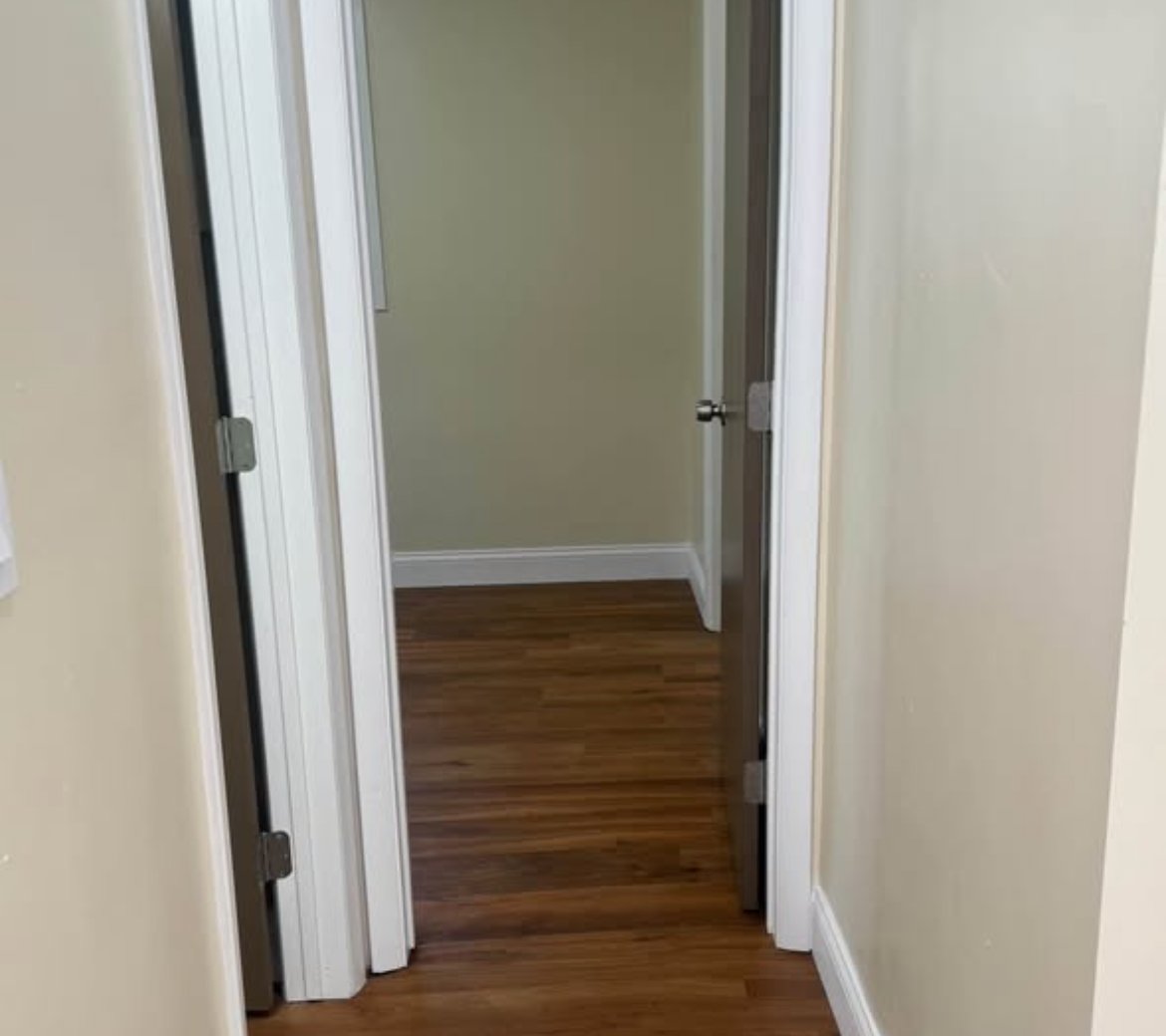 Hallway with wood-look floors and white trim at 2103 N C St