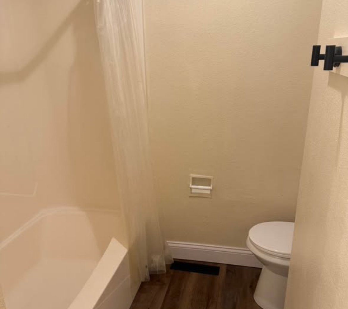 Bathroom with bathtub and toilet at 1702 W Olive St